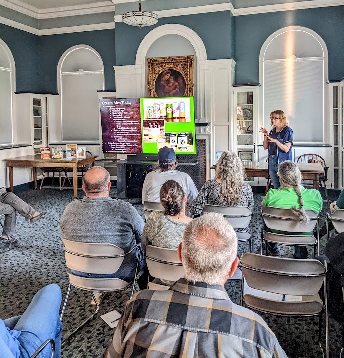 Michelle lecturing our Ale Together Now program in the Community Room. 