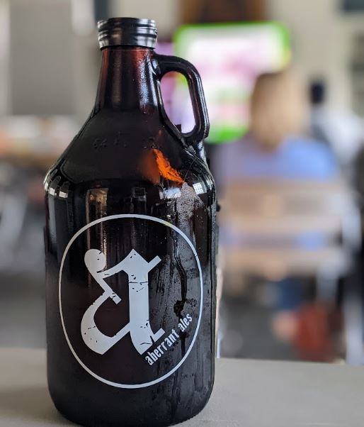 A growler of Aberrant Ales beer in the Community Room. 