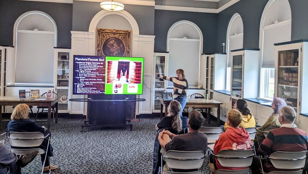 Michelle lecturing our Ale Together Now program in the Community Room. 