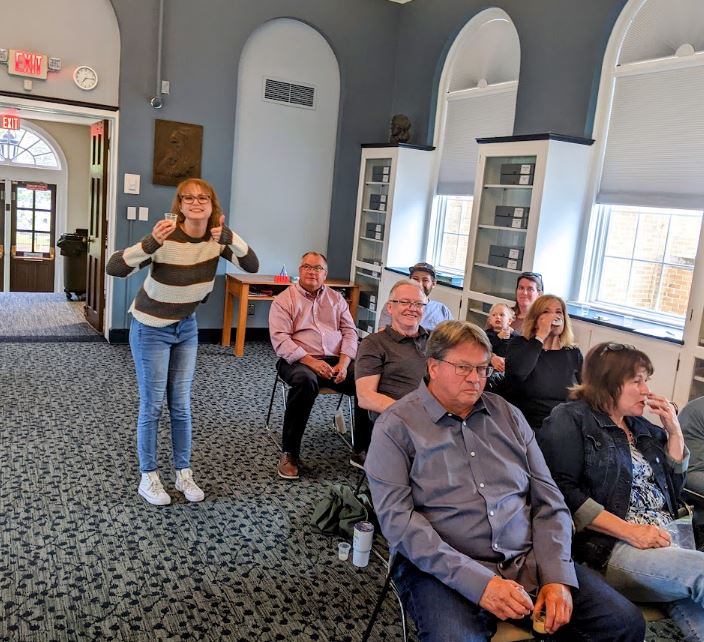 Michelle standing near the seated audience during Ale Together Now. 
