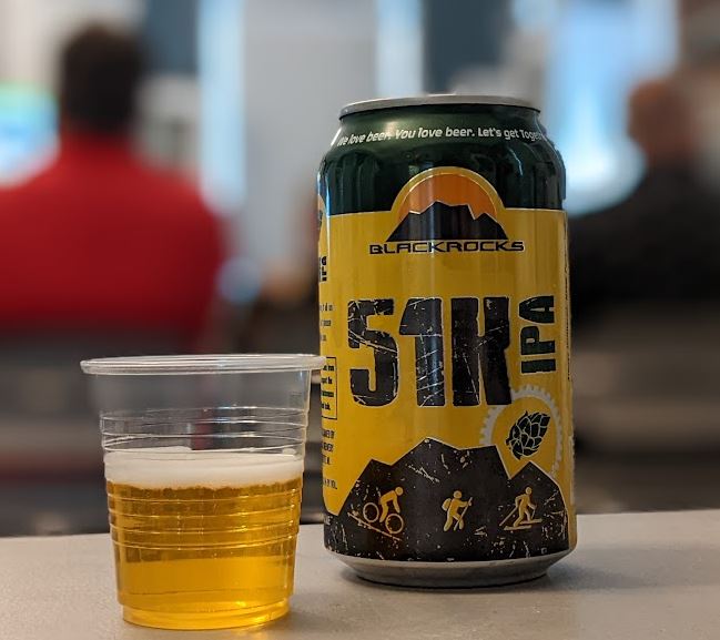 A can of 51K IPA, with a small sample poured into a 3-oz cup, in the Community Room during an Ale Together Now program. 