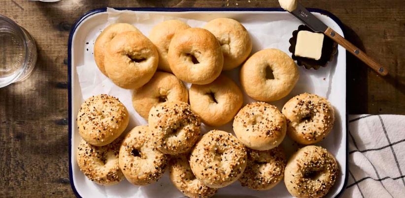 A variety of sourdough bagels on a tray. 