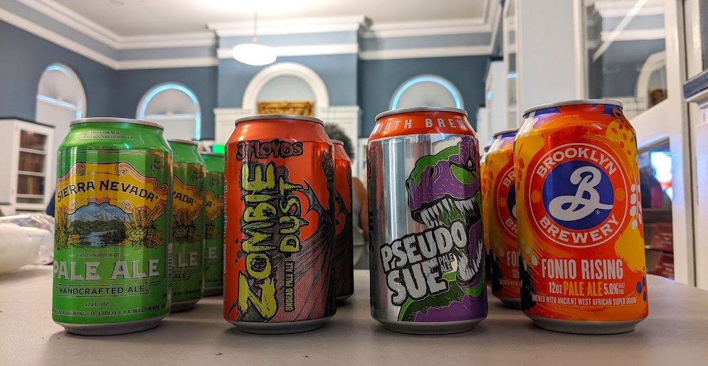 Four cans of pale ale in the Community Room. 