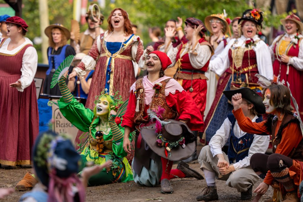 A group of folks in costume enjoying the Renaissance Festival. 