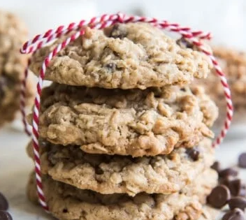 Oatmeal toffee chocolate cookies with a red and white yarn tie. 