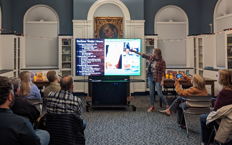 Michelle lecturing our Ale Together Now program in the Community Room. 