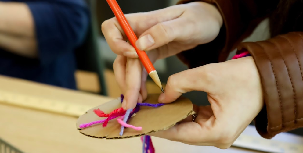 A close up look at a weaving project in process. 