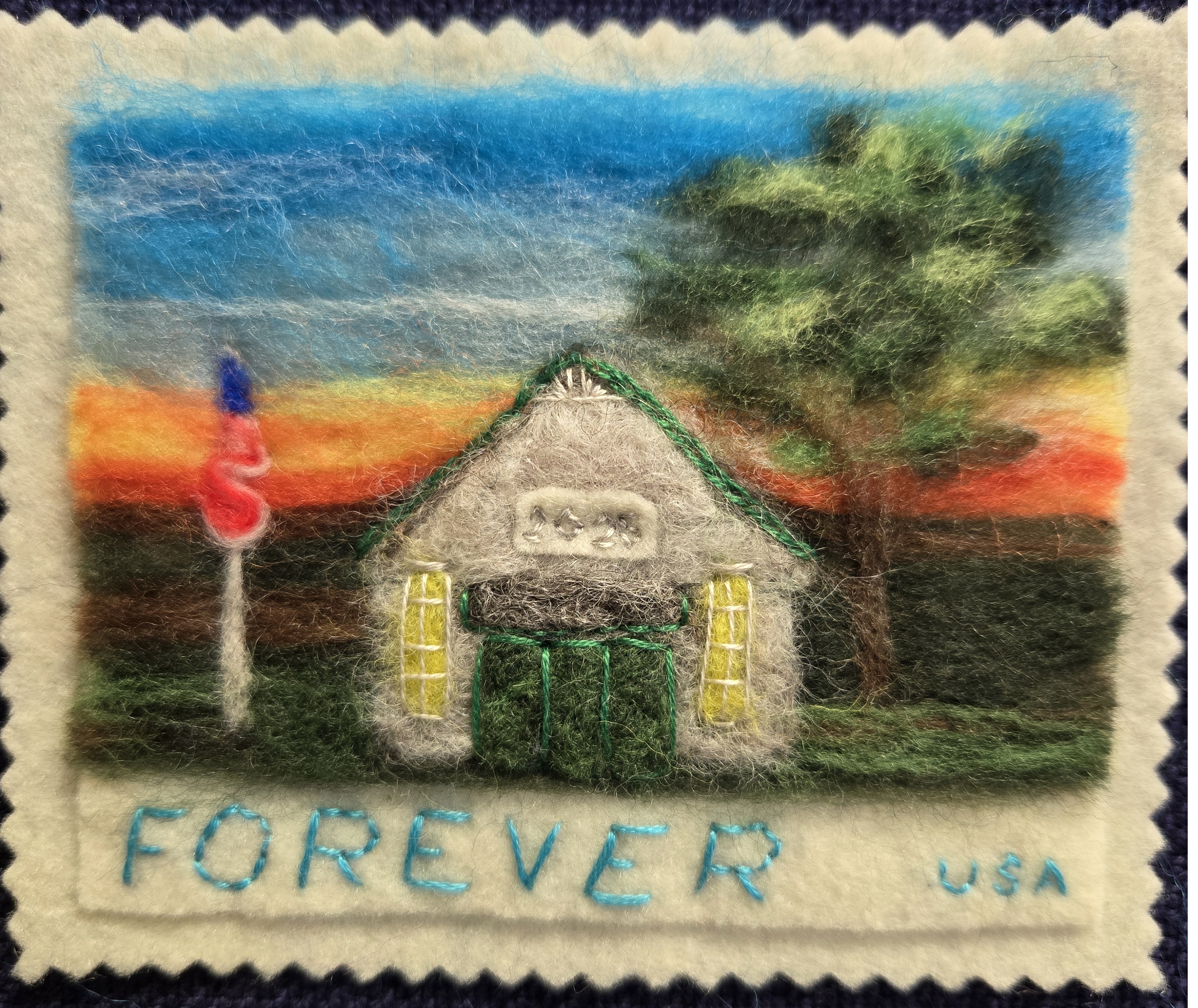A needle felted scene of a postage stamp.