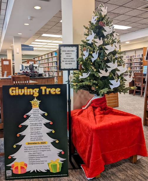 The Giving Tree and accompanying poster on the first floor of the Library. 