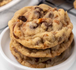Three cookies stacked on a white plate. 