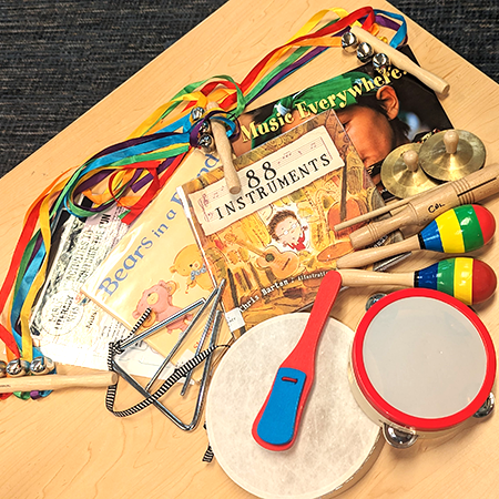 Materials laid out on a table, included in the Music Time Early Literacy Kit. 