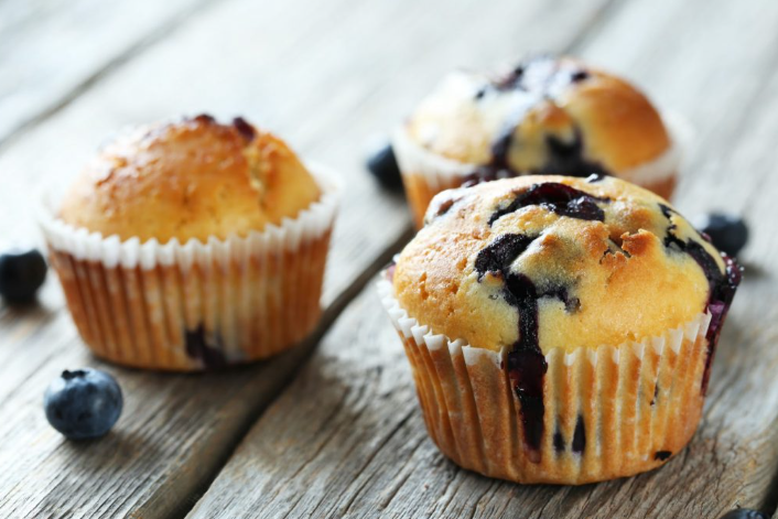 Blueberry muffins on a wooden surface. 