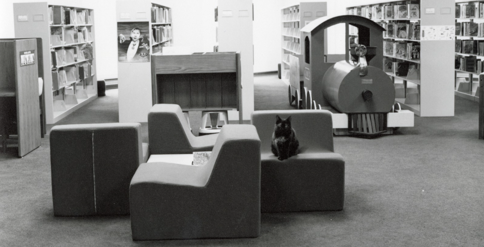 Rachel sits proudly on the furniture of the brand-new Youth department. 