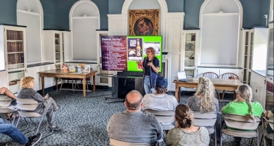 Michelle lecturing our Ale Together Now program in the Community Room. 