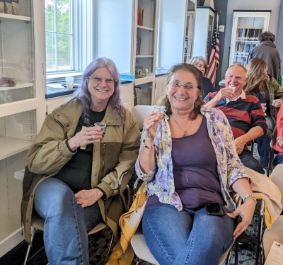 Library patrons Sharon and Mary enjoying small beer samples during an Ale Together Now program in the Community Room. 