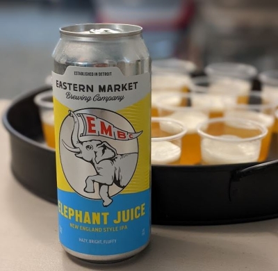 A can of Elephant Juice IPA in front of a tray filled with beer sample cups during an Ale Together Now program. 