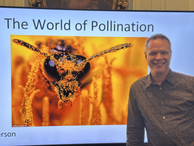 Brian standing in front of his World of Pollination presentation. 