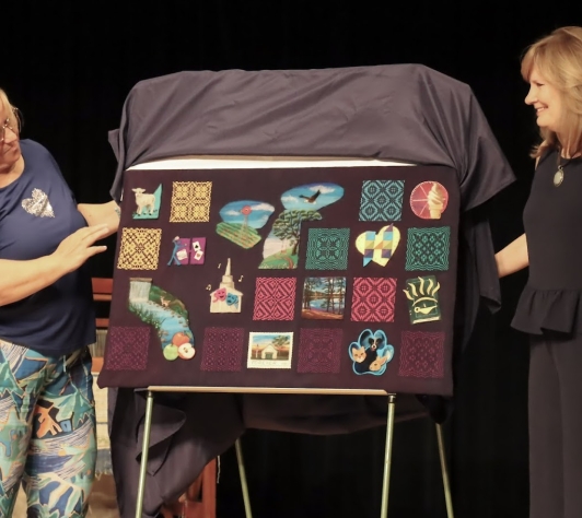 Artists Gisela and Cindy unveil their woven art piece for Art Walk 2025. 