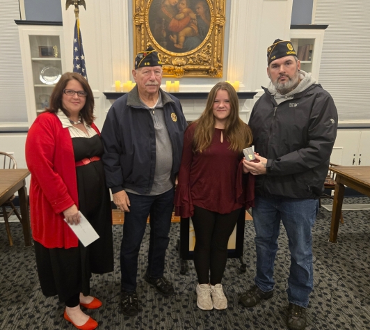 Gold winner of the Grant Sweet Memorial Essay Contest with local veterans and Library staff in the Community Room. 