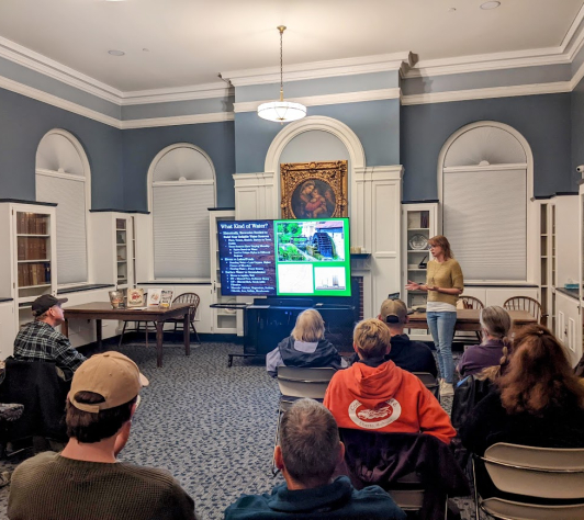 Michelle lecturing our Ale Together Now program in the Community Room. 