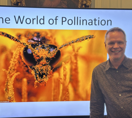 Brian standing in front of his World of Pollination presentation. 