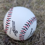 white baseball on grass. 