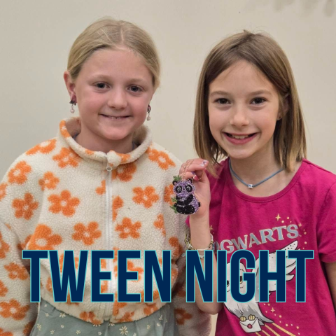 Two tweens in the Youth Program Room posing together-- one is holding a handmade keychain craft. 