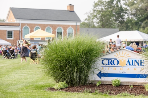 A Summer Concert on the South Lawn, viewed with the Cromaine Library sign in the forefront. 