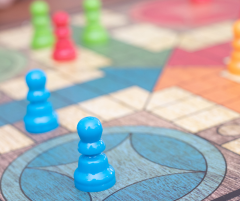 A close up photo of game pieces on a board game. 