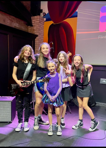 UltraViolet5 posing together onstage. 