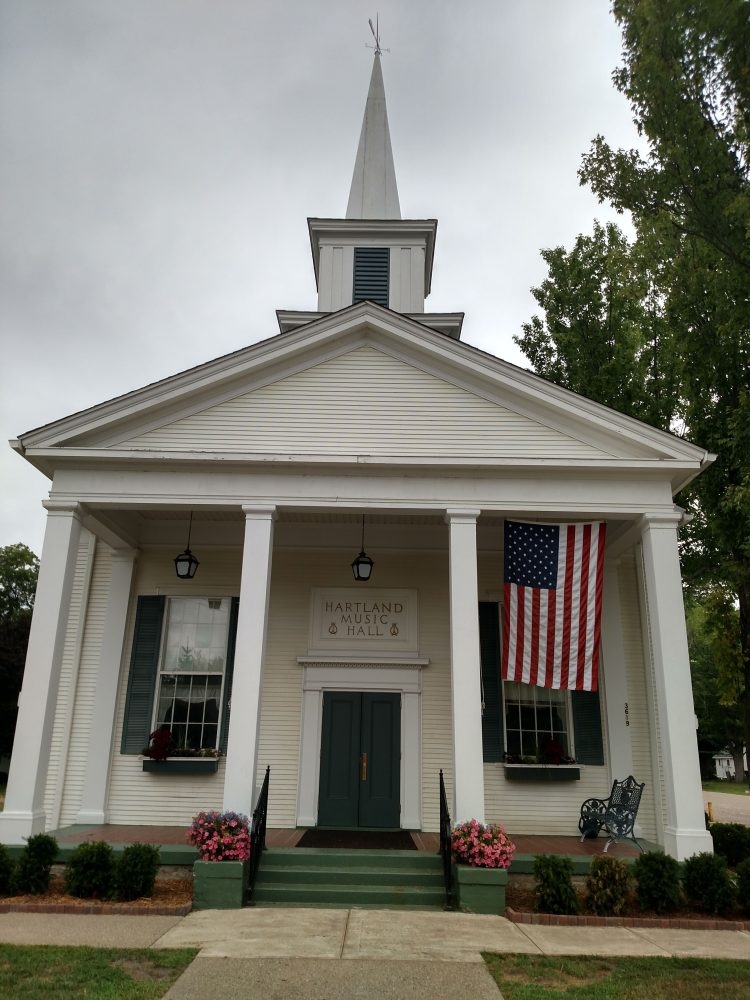 A street-facing view of the Hartland Music Hall in spring. 