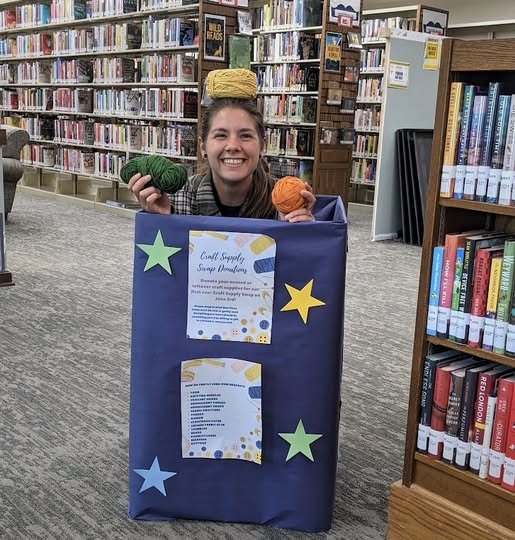 Shelby in a craft donation box in the Library! 