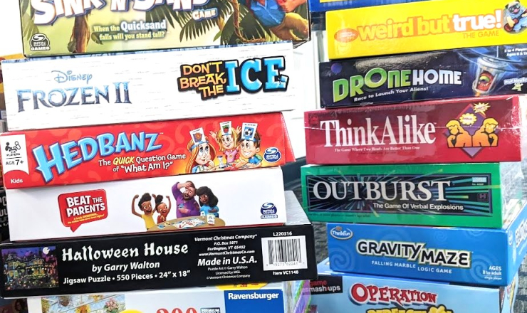 A pile of games and puzzles in the Community Room. 