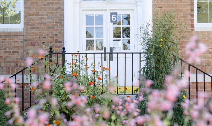 Cromaine Library 1927 entrance, behind pink flowers. 